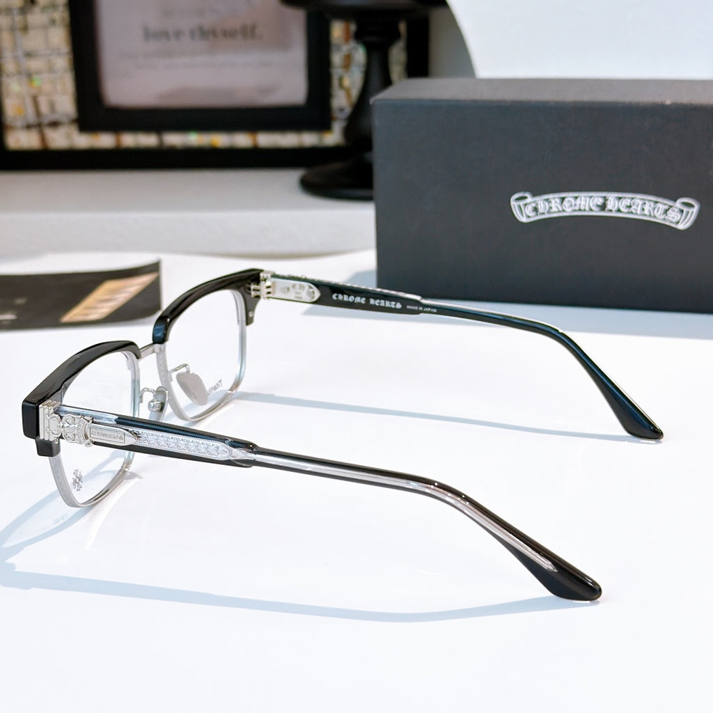 Silver eyeglasses with black temples, close-up side view and hinges