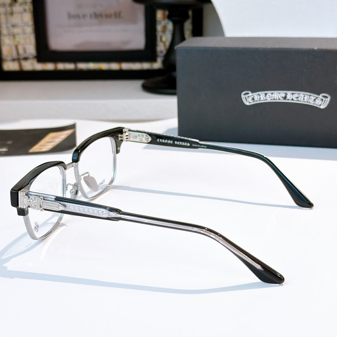 Silver eyeglasses with black temples, close-up side view and hinges