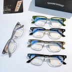 Assorted eyeglasses with clear lenses: green, black, and blue frames