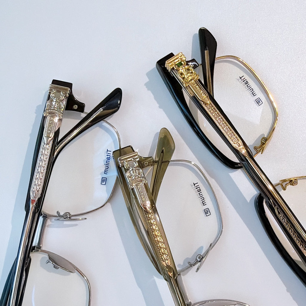 Gold and silver eyeglasses set with clear lenses and patterned temples