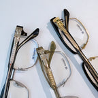 Gold and silver eyeglasses set with clear lenses and patterned temples