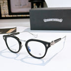 Black round-frame glasses with clear lenses and metal temples, with small logo detail.