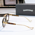 Tortoiseshell and gold glasses with thin gold temples and clear lenses; logo near hinge.