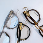 Two pairs of glasses: silver with transparent arms and gold-tortoiseshell frame with clear lenses.