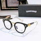 Black and gold cat-eye glasses with clear lenses and gold-tone temples; logo on front.