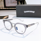 Silver round-frame glasses with clear lenses and thin metal temples; small logo on bridge.