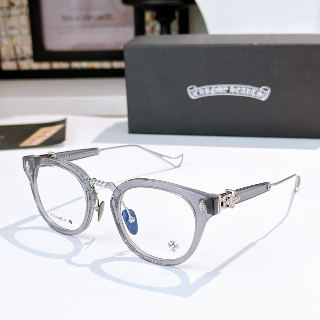 Silver round-frame glasses with clear lenses and thin metal temples; small logo on bridge.