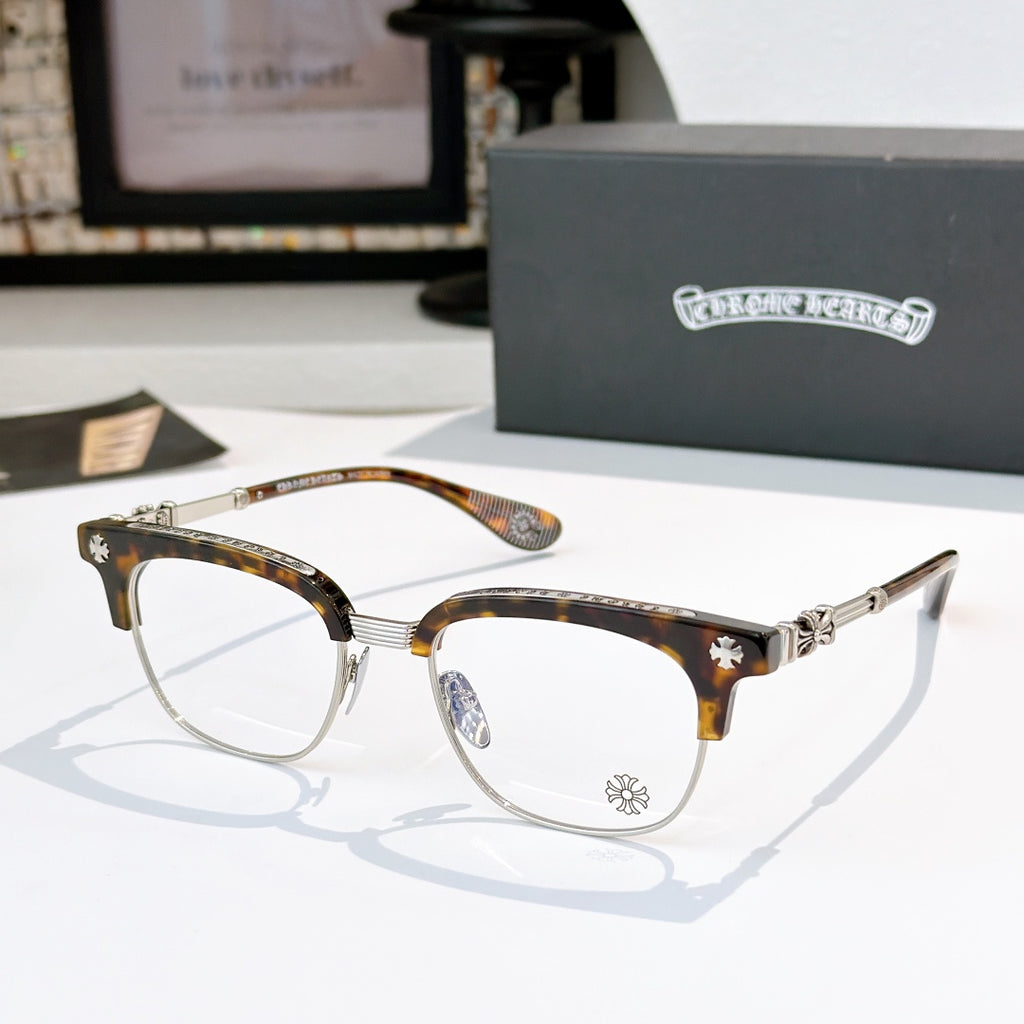 Chrome glasses with clear lenses, tortoise frame with gold-tone arms and star detail