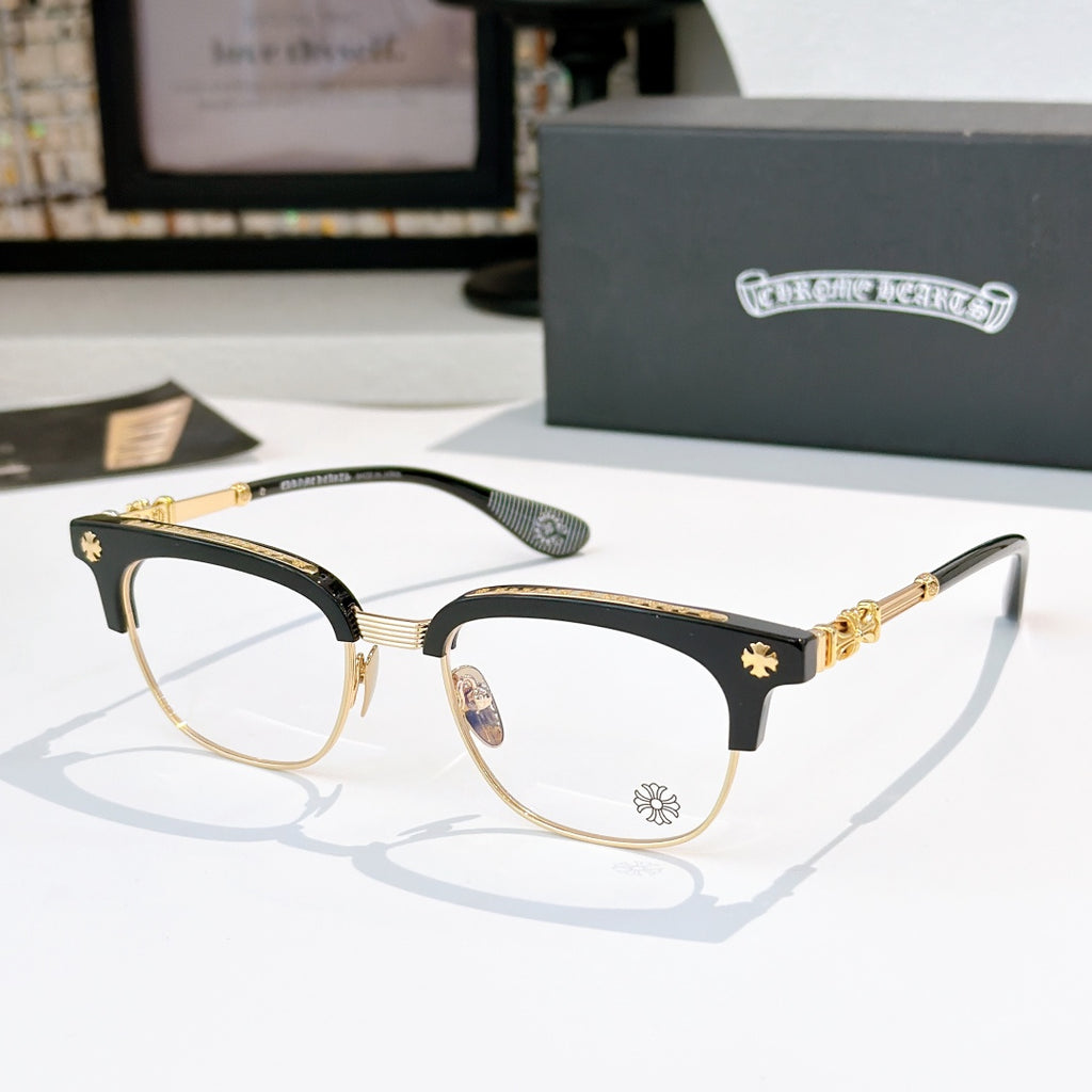 Chrome glasses with clear lenses, black frame with gold-tone details and star accents