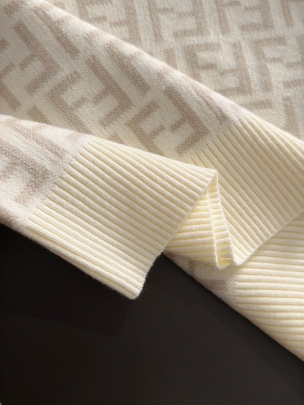 Cream sweater cuff and hem with ribbed knit and Fendi FF pattern