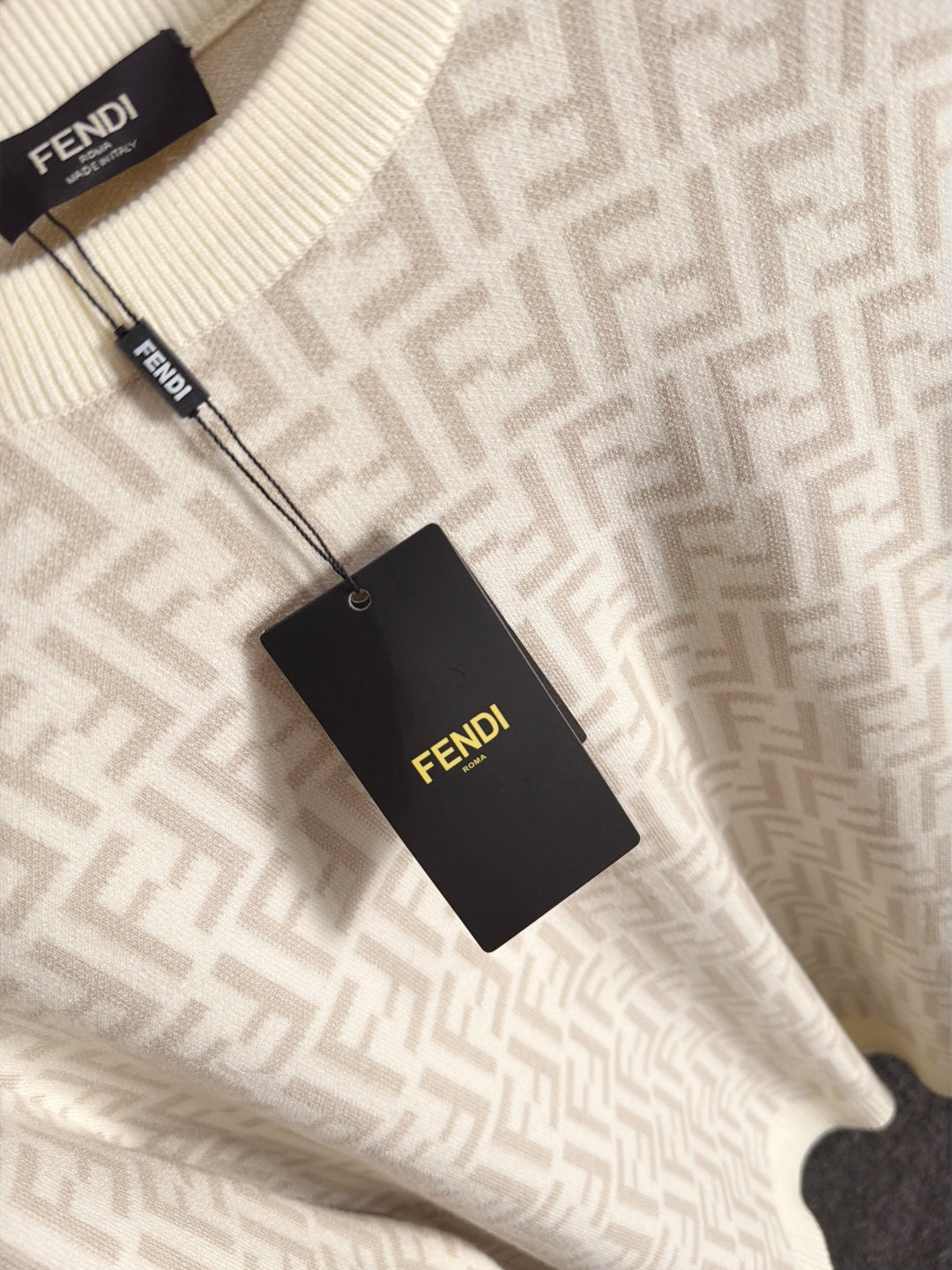 Cream knit sweater with allover Fendi FF pattern and Fendi hangtag