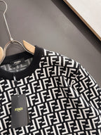 Fendi long-sleeve knit top close-up, black with white FF logo pattern at chest