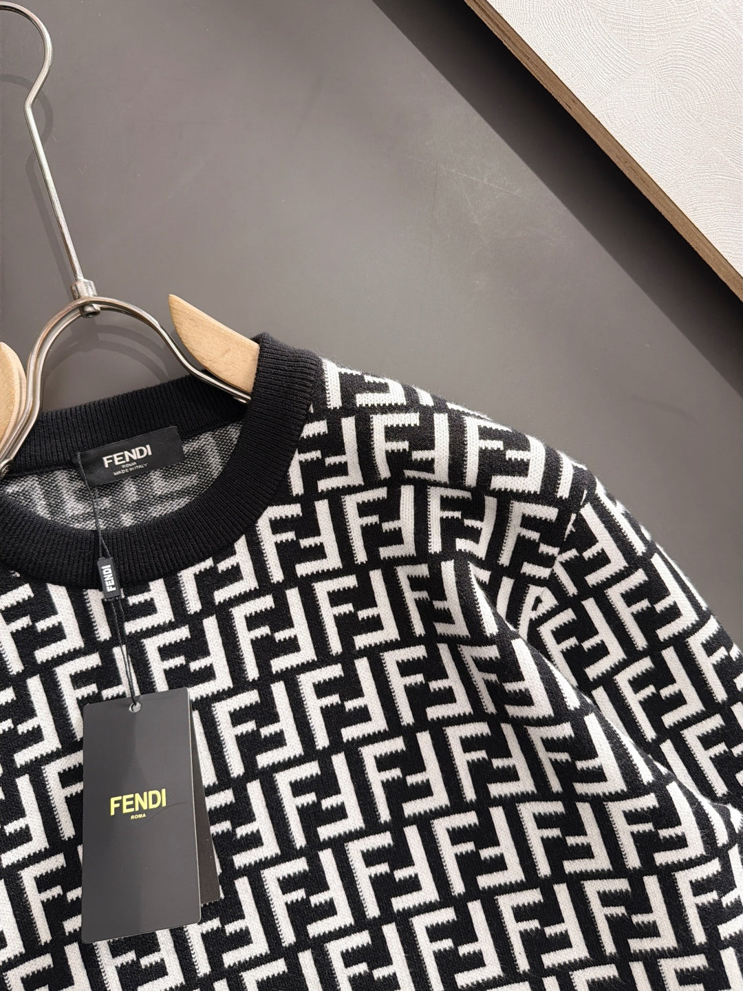 Fendi long-sleeve knit top close-up, black with white FF logo pattern at chest