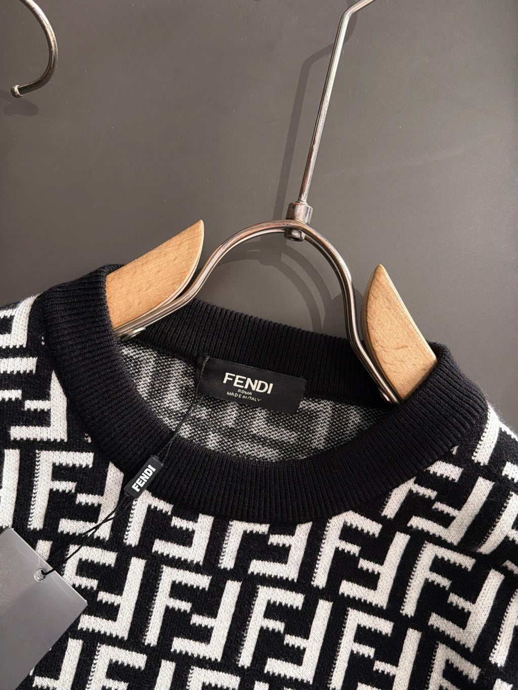 Fendi long-sleeve knit top neckline close-up, black knit with white FF logo