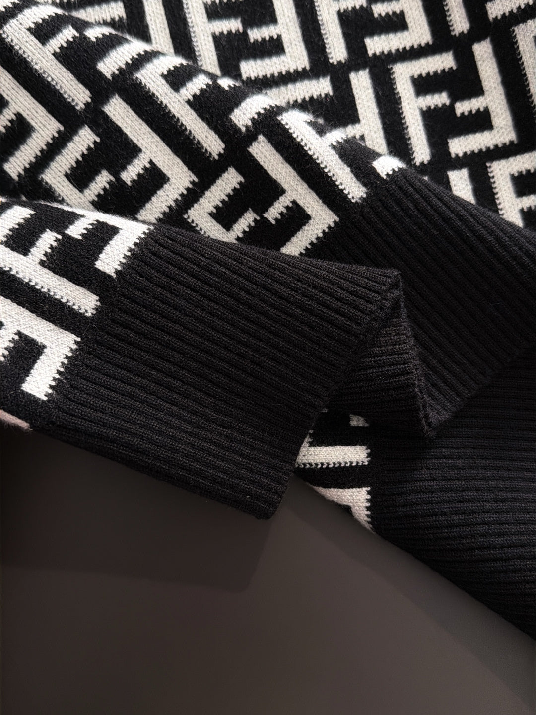 Fendi long-sleeve knit top cuff detail, black ribbed trim with white FF logo