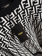 Fendi long-sleeve knit top front close-up, black with white FF logo and tag