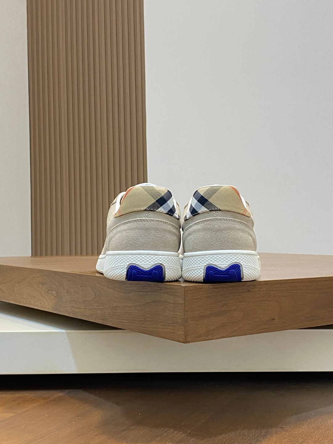 Tan sneakers with blue heel tab and blue-check collar panel
