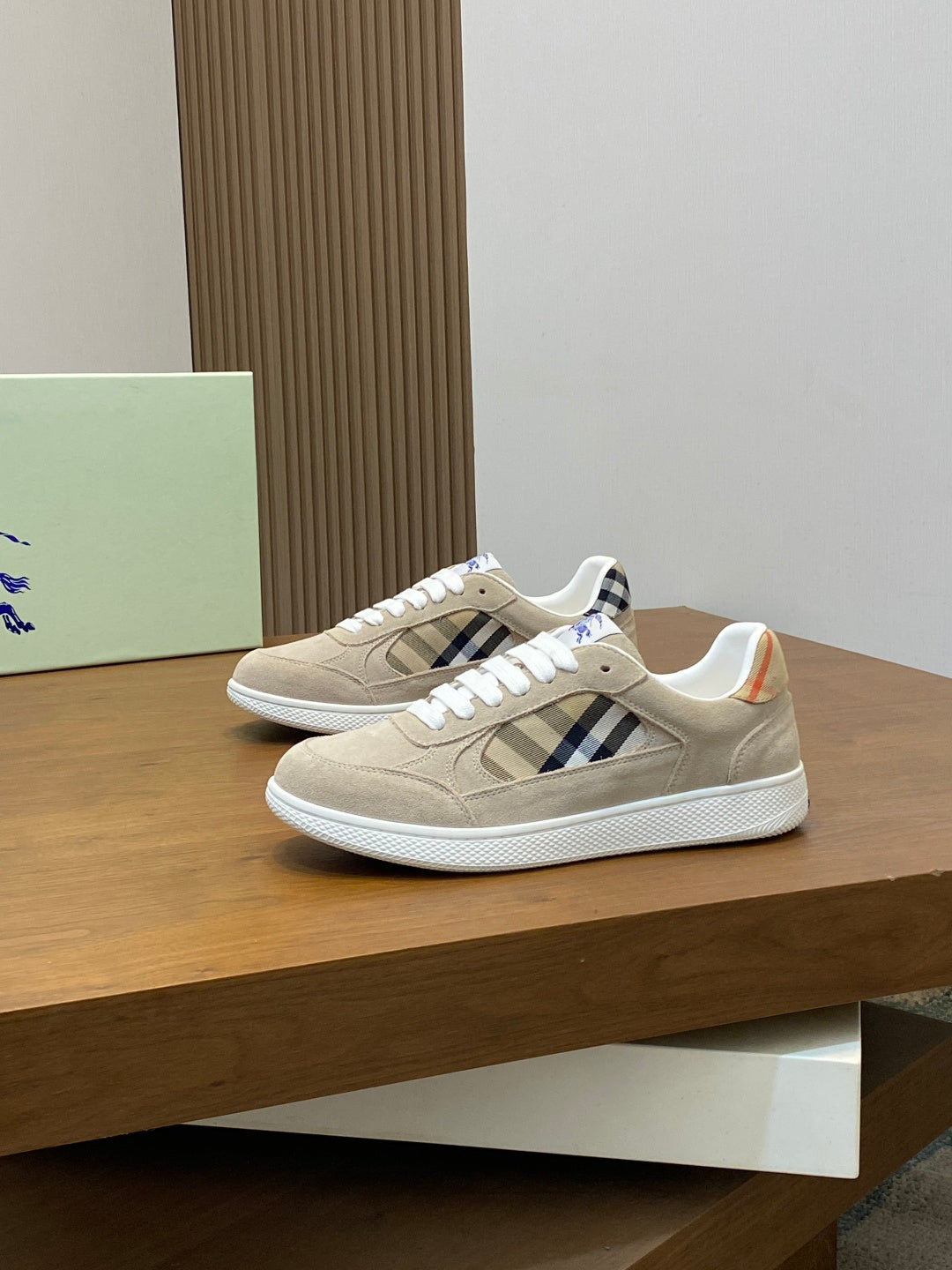 Tan suede sneakers with blue plaid quarter panel and white toe cap