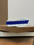 White outsole with blue Burberry-style branding and traction tread