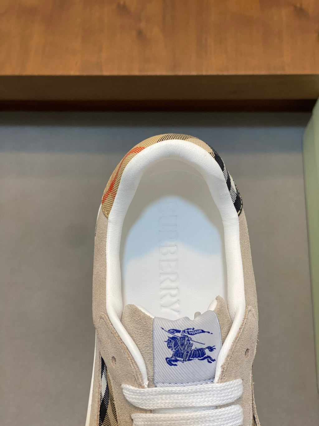 Burberry logo insole with blue graphic on tan sneaker lining