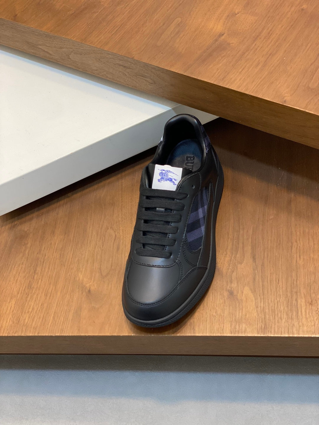 Burberry lace-up sneakers in dark leather with blue plaid lining, low profile