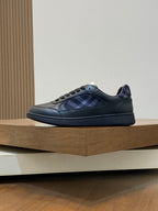 Burberry low-top sneakers with blue plaid lining, lace-up front, dark leather
