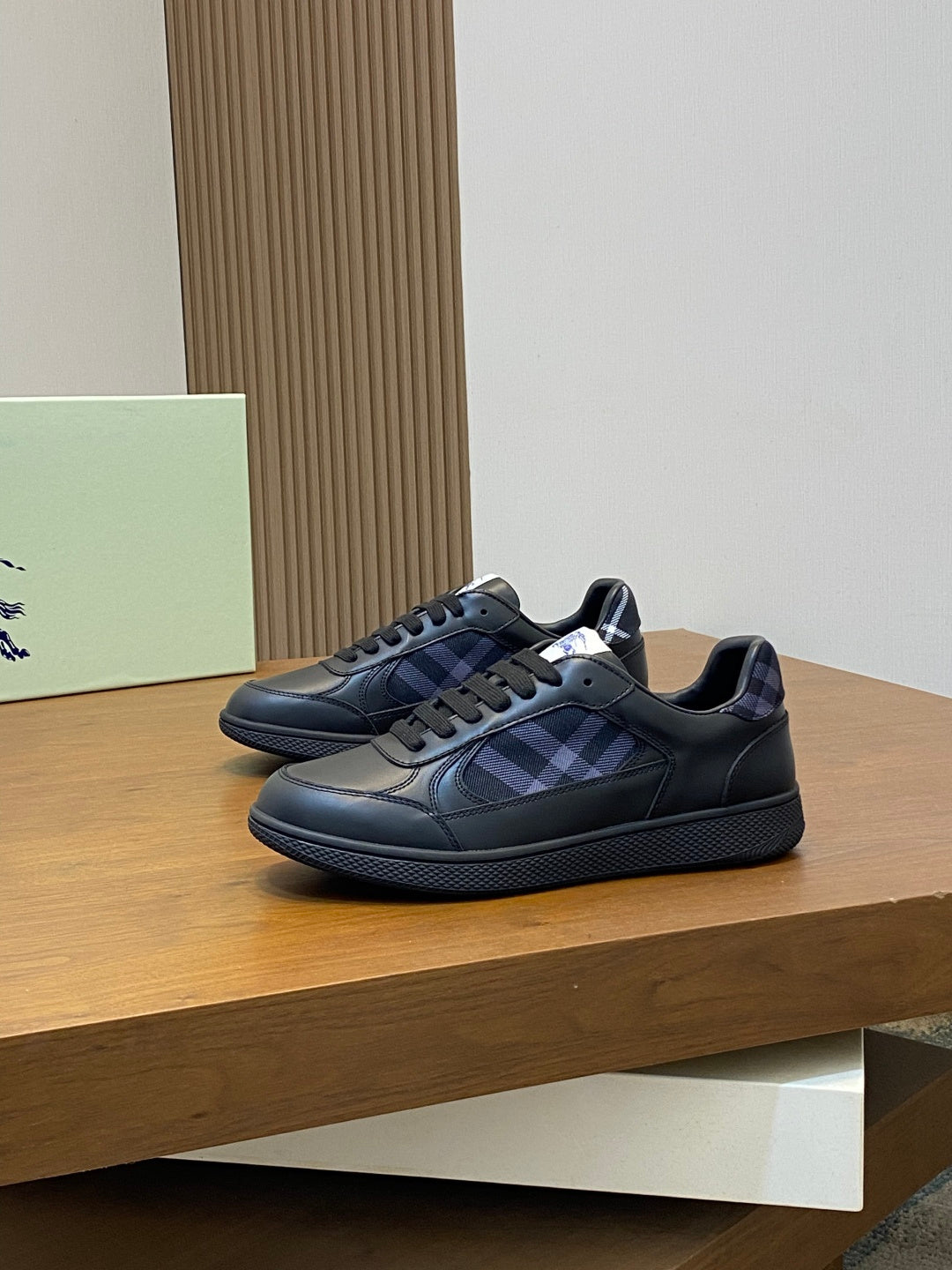 Burberry sneakers with blue plaid side panel, dark leather upper, lace-up