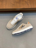 Tan and white sneakers with blue check inset and blue logo sole