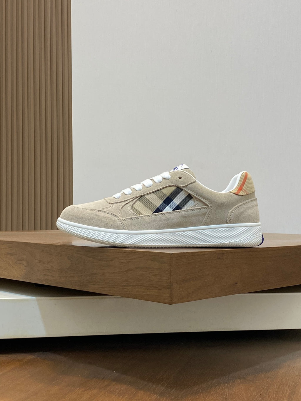 Tan suede low-top sneakers with blue check panel and white soles
