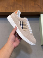 Tan suede sneaker with blue plaid side panel and white laces