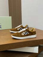 Brown suede sneakers shown from front three-quarter view with check panel and white laces