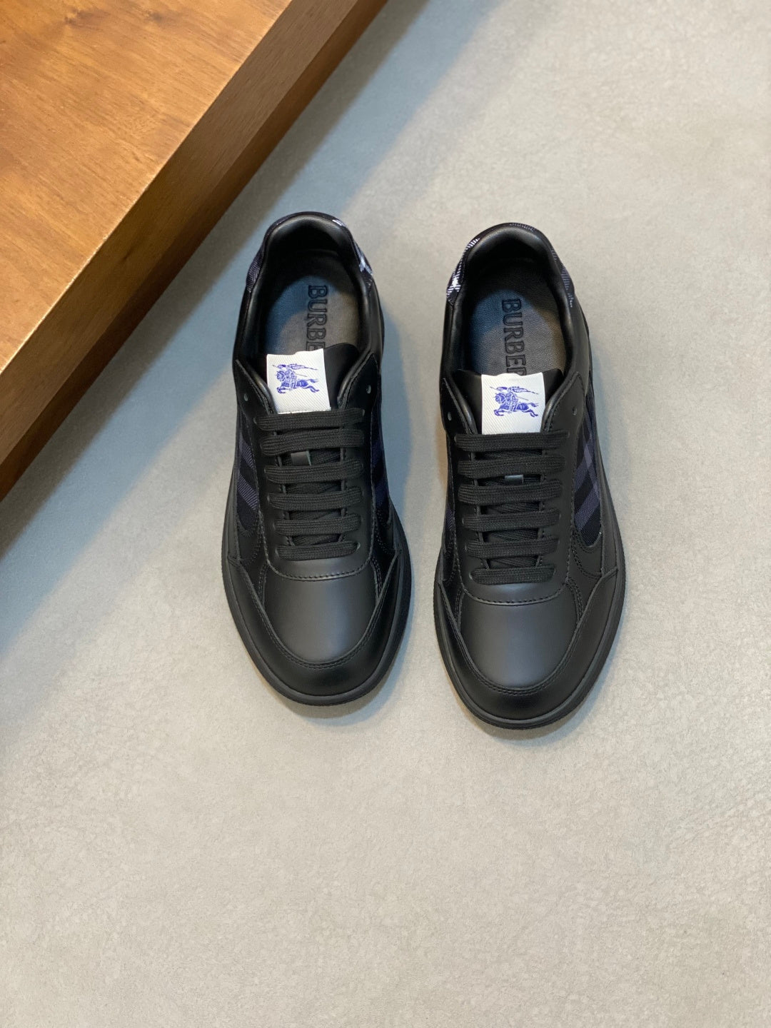 Burberry lace-up sneakers in dark leather with blue plaid panels and rubber sole