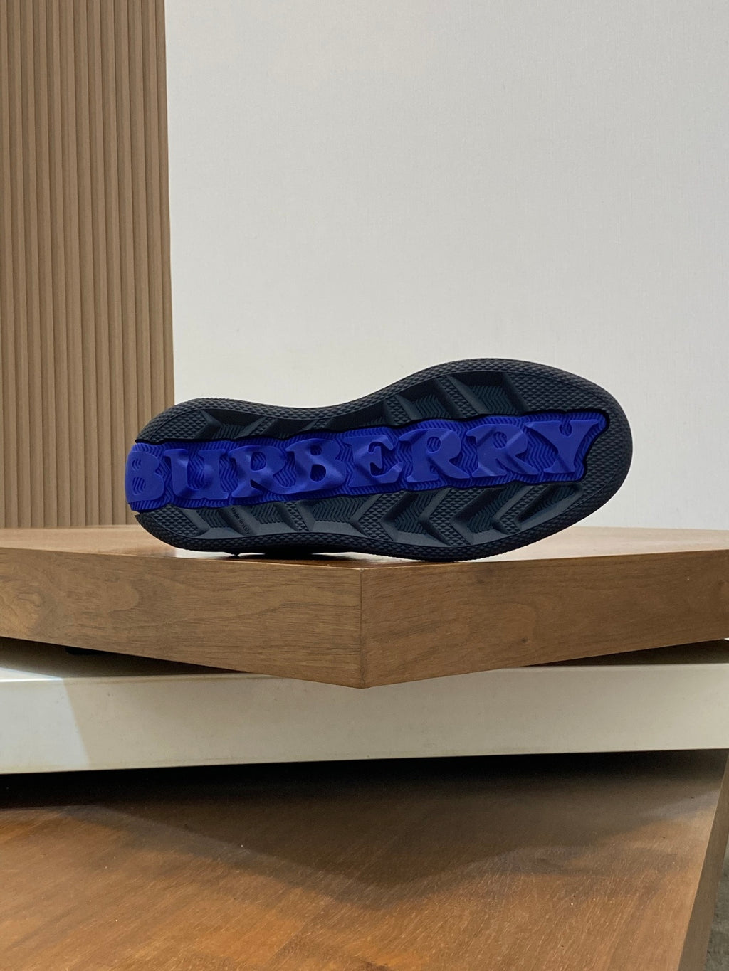 Burberry sneaker outsole with blue tread lettering, dark sole underside