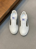 White Burberry sneakers with plaid side panel and lace-up front.