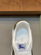 White sneaker interior with Burberry logo and blue plaid accent.