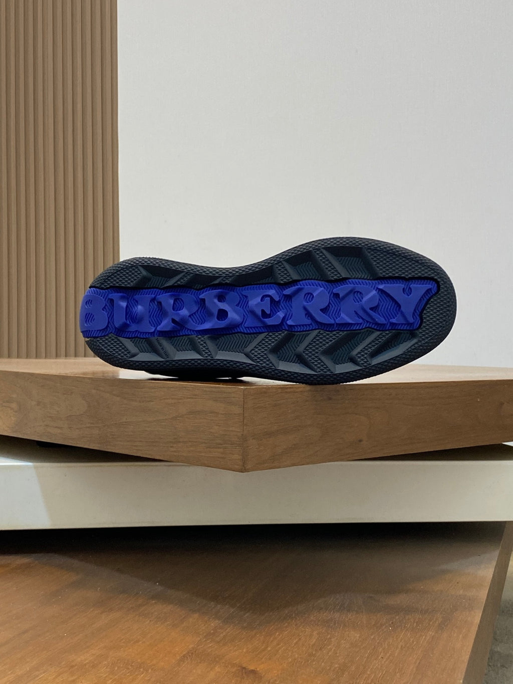 Burberry low-top sneaker outsole, blue tread with raised logo lettering