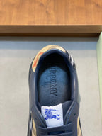 Burberry low-top sneaker close-up, blue interior lining with check heel trim
