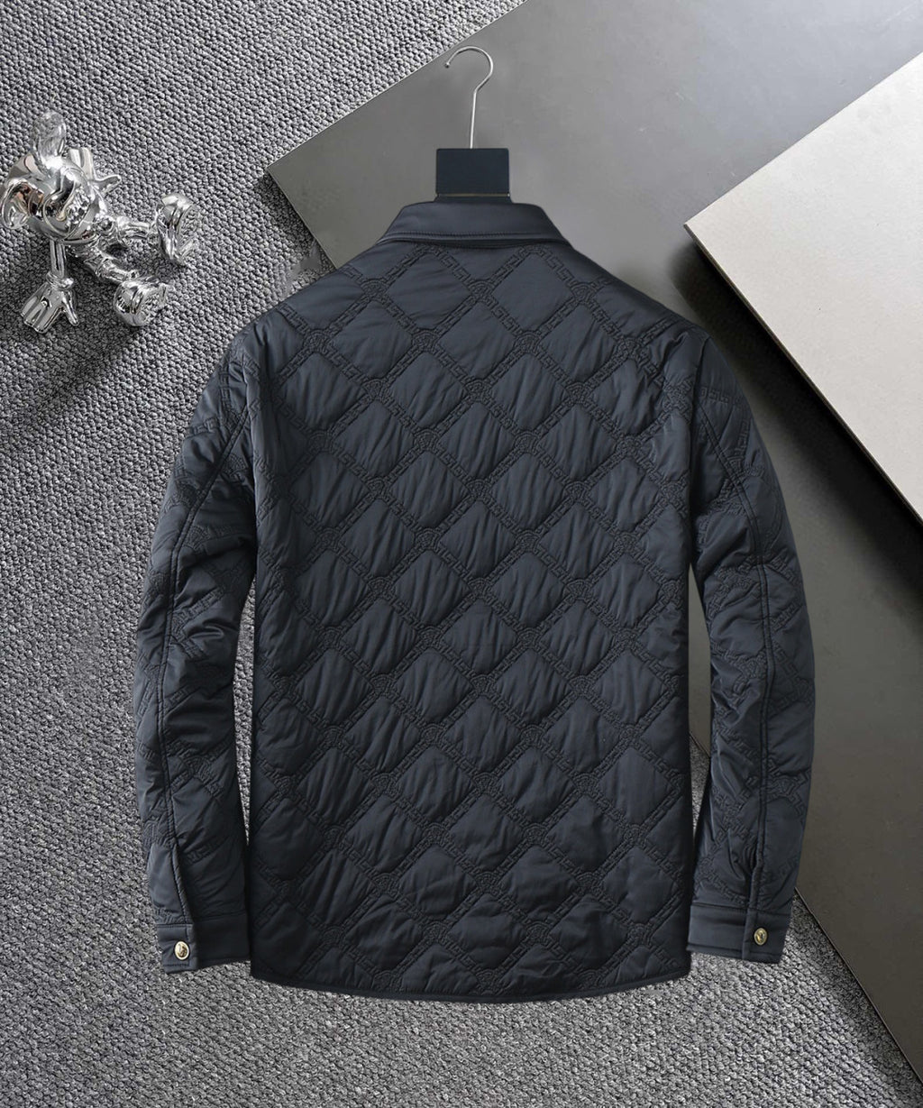 Quilted jacket back view, black with stitched diamond pattern and gold snaps