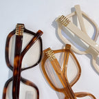 MiuMiu eyeglasses frames with tortoiseshell and cream colors, gold-tone hinges