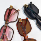 Assorted oversized sunglasses with brown, pink, and black frames and tinted lenses