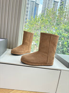 Tan suede mid-calf pull-on boots, side view with low flat sole