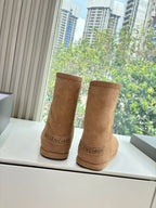 Tan suede mid-calf pull-on boots with Balenciaga logo at back