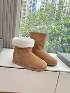 Tan suede mid-calf pull-on boots with white shearling lining on display