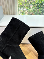 Black suede ankle boots, close-up of side seam and heel area
