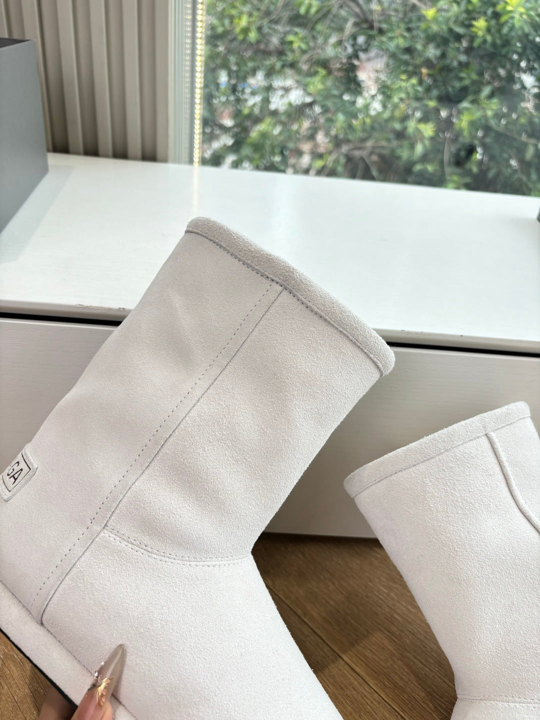 Balenciaga ladies suede ankle boots, light beige, close side view of seam and toe