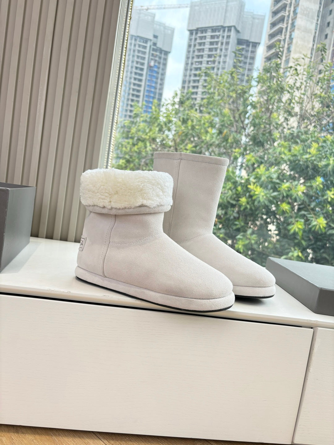 Balenciaga ladies suede boots with sherpa lining, light beige, pair on display