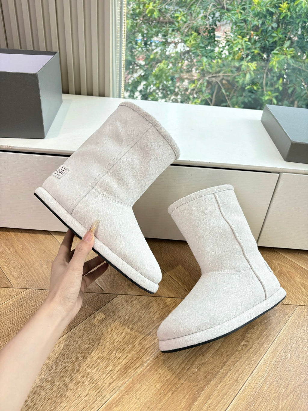Balenciaga ladies suede ankle boots, light beige, angled side view on floor