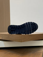 Prada sneakers outsole view with deep rubber tread pattern.