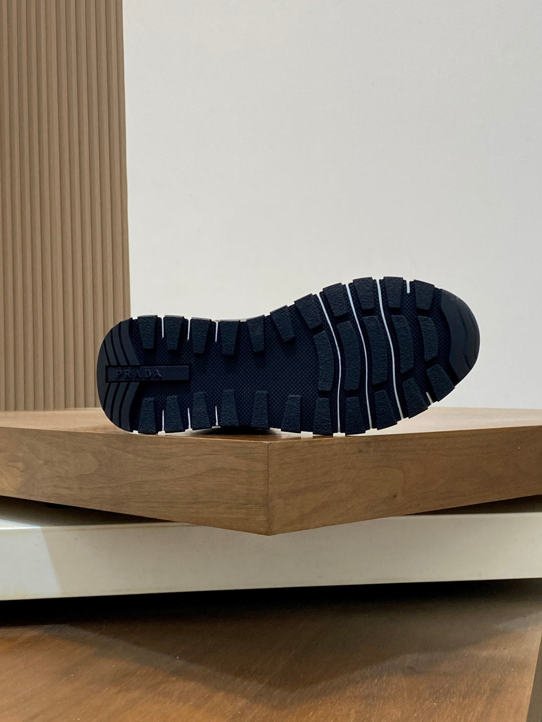 Prada sneakers outsole view with deep rubber tread pattern.