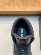 Prada sneaker tongue close-up in dark fabric with logo branding.